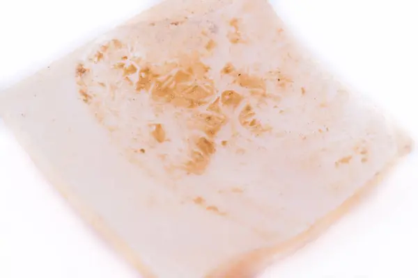 Macro mineral nacre stone, pearl, mother-of-pearl on a white bac — Stock Photo, Image