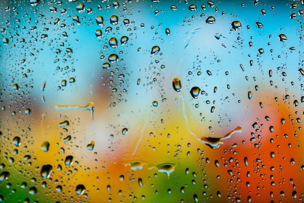Beautiful multi-colored water droplets on a glass — Stock Photo, Image