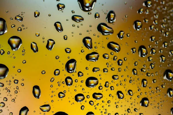 Beautiful multi-colored water droplets on a glass — Stock Photo, Image