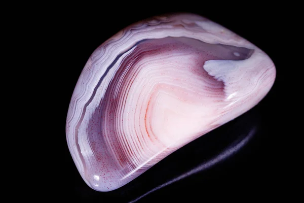 Macro mineral stone Agate pink Persian on a black background — Stock Photo, Image