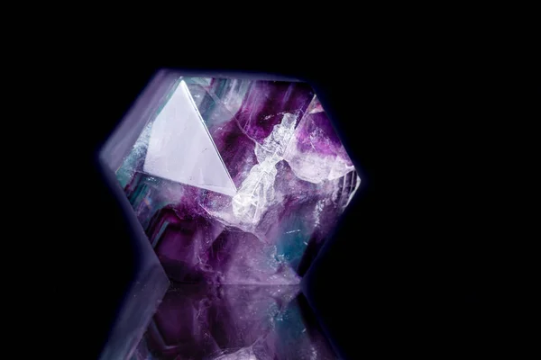 Macro mineral stone Fluorite crystal on a black background