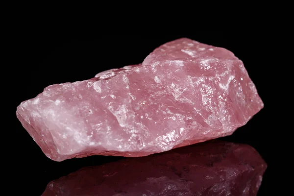 Macro mineral stone Pink quartz on black background