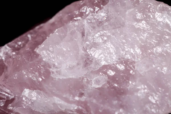 Macro mineral stone Pink quartz on black background