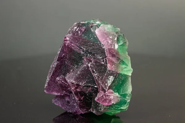 macro mineral stone green and purple fluorite on a black backgro