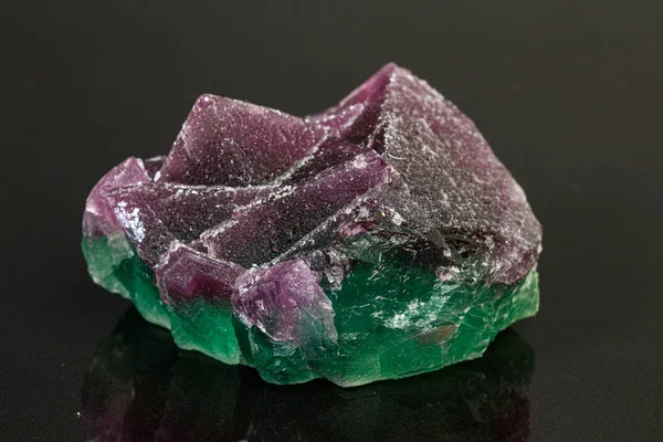 Macro mineral stone green and purple fluorite on a black backgro — Stock Photo, Image