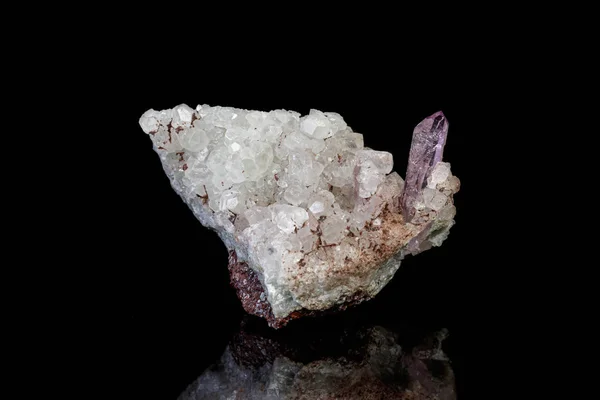 Macro mineral amethyst stone in rock on a black background — ストック写真