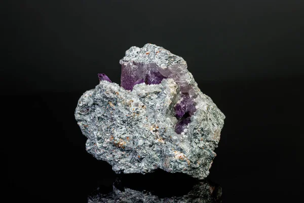 Macro mineral amethyst stone in rock on a black background — Stock Photo, Image