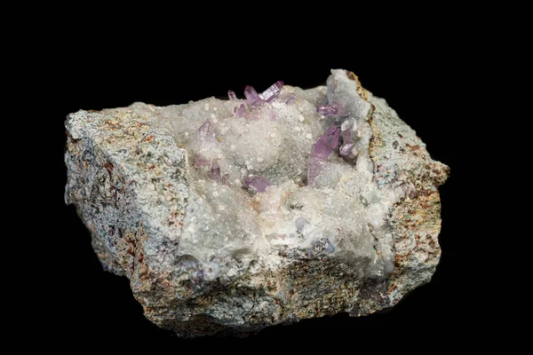 Macro mineral amethyst stone in rock on a black background — ストック写真