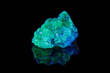 siyah bir sırt üzerinde ultraviyole ışık altında makro mineral taş opal