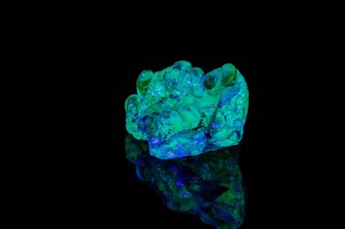 siyah bir sırt üzerinde ultraviyole ışık altında makro mineral taş opal