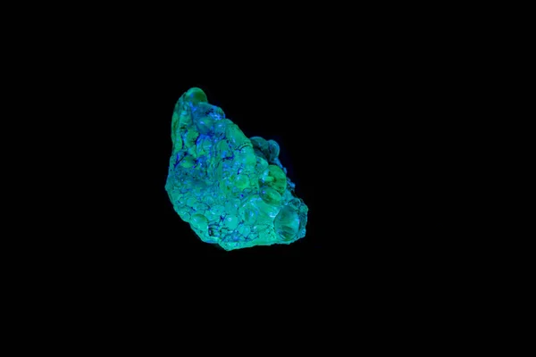 macro mineral stone opal under ultraviolet light on a black back