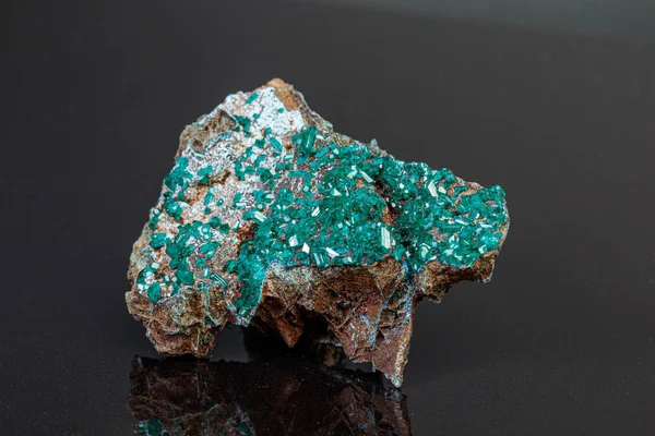 Macro mineral stone Dioptase on a gray background — Stock Photo, Image