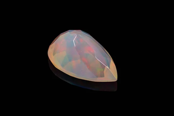 Macro mineral stone faceted opal on a black background — Stock Photo, Image