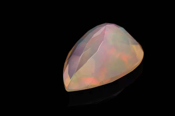 Macro mineral stone faceted opal on a black background — Stock Photo, Image