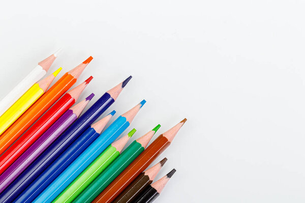 macro multicolored pencils on a white background
