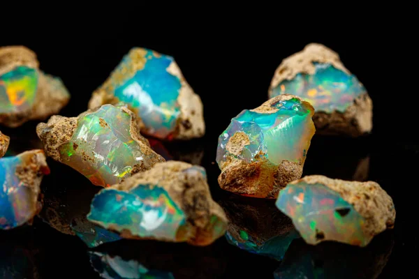 Macro mineral stone rare and beautiful opals on a black backgrou — Stock Photo, Image