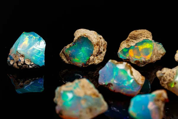 Macro mineral stone rare and beautiful opals on a black backgrou — 스톡 사진