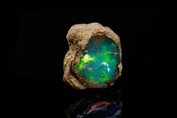 Macro mineral stone rare and beautiful opals on a black backgrou — Stock Photo, Image