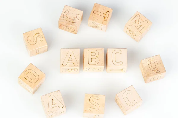 Wooden cubes with letters ABC on a white background