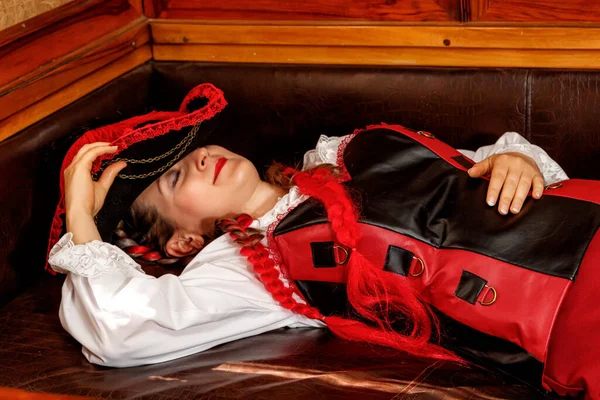 beautiful girl in steampunk costume in an old train carriage close-up