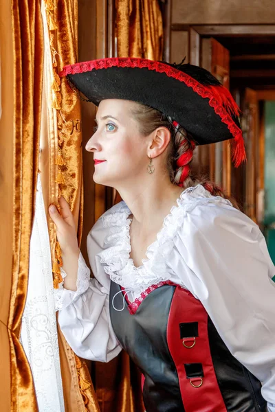 beautiful girl in steampunk costume in an old train carriage close-up