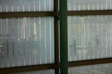 Pattern shadow picture of people reflected in the glass of the window frame in front of the station                               