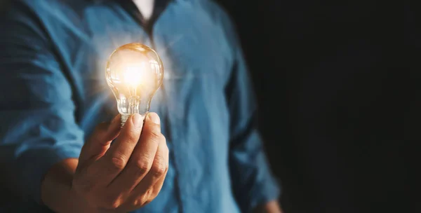 Businessman hand holding lightbulb. idea Alternative energy conc — Stock Photo, Image