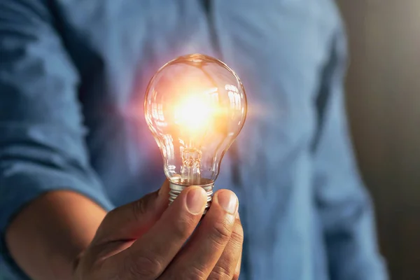 Бізнесмен рука тримає лампочку. ідея Альтернативна енергія — стокове фото