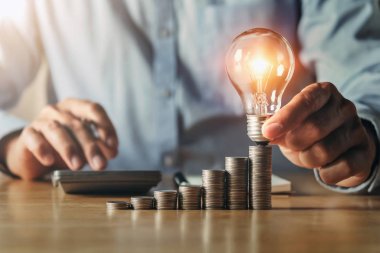businessman hand holding light bulb. idea concept with innovatio