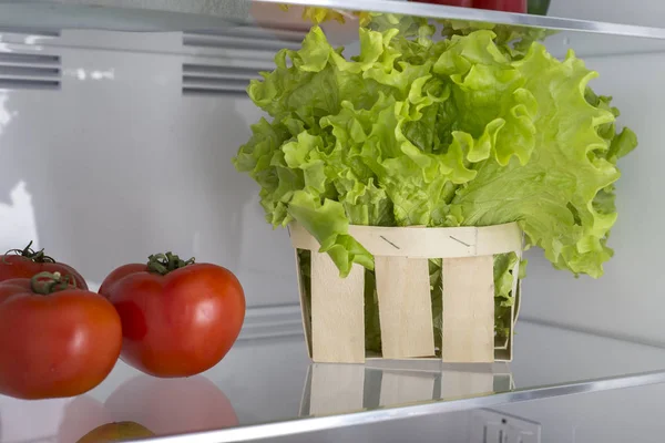 Open fridge full of fresh fruits and vegetables