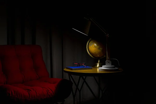 Lamp illuminating reading place with red armchair. Residence interior.