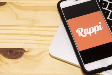 December  24, 2019, Brazil. Rappi logo on the mobile device. Rappi is an on-demand delivery startup active in Argentina, Brazil, Chile, Colombia, Mexico, Peru, and Uruguay. clipart