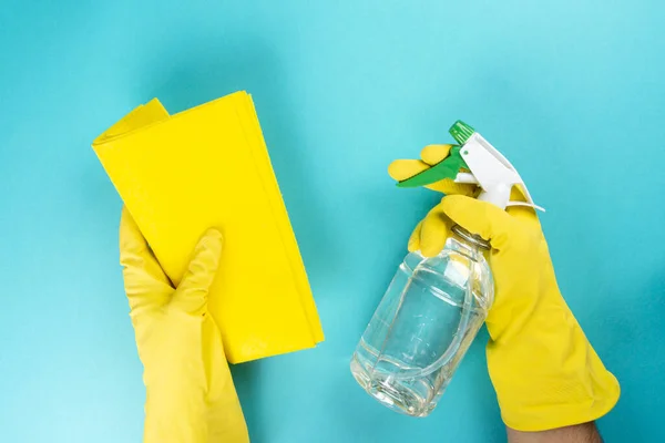 Man with protective rubber glove with microfiber cloth and alcohol spray for cleaning, Wiping down surface concept.