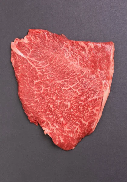 Fresh marbled beef steak on a black slate board — Stock Photo, Image