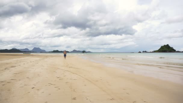 Homem correndo na praia. — Vídeo de Stock