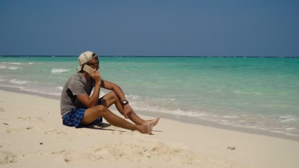 Mężczyzna z telefonu komórkowego na plaży. — Wideo stockowe