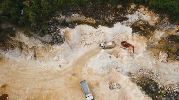 Bagger verlädt LKW im Steinbruch. philippinen, siargao. — Stockvideo