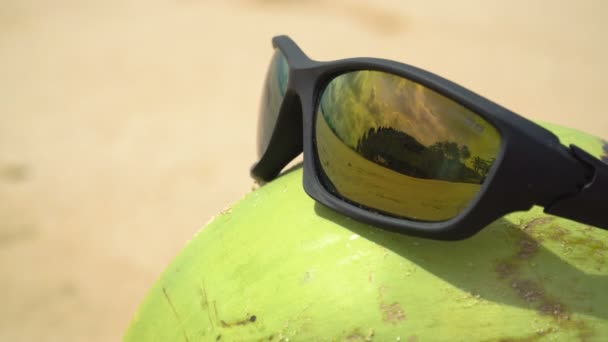 Sunglasses on coconut — Stock Video
