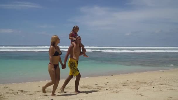 Family with child on the beach. — Stock Video