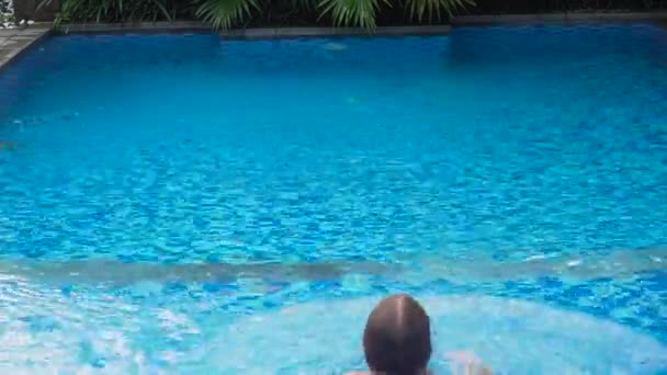 Dívka se koupe v bazénu. — Stock video