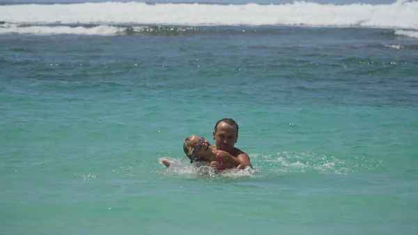 Padre e hija juegan en el mar . — Foto de Stock
