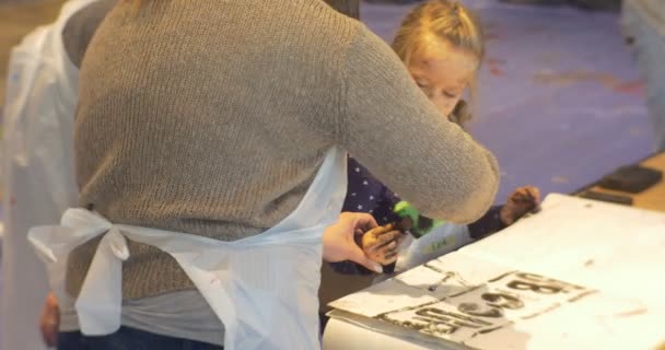 Mama nauczyciel szczęśliwy mała dziewczynka dzieci malarstwo czarne Put znaczki litery malarstwo w galerii sztuki Classroom wychowawcy animatorzy zabawiać rodzin dzieci — Wideo stockowe