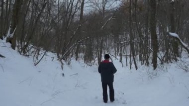Sviatogorsky Mağarası Manastırı Milli Parkı ve sakallı bir adam kışın esrarengiz Yayilim çıplak ağaçları ile kaplı, yamaçlar boyunca yürüyüş