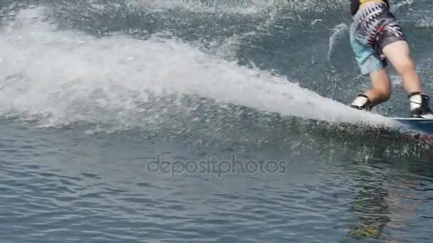 Спортсмен проходить вейкбординг і повертає ліворуч, залишаючи вражаючою хвилі після його в деяких Wake парк — стокове відео