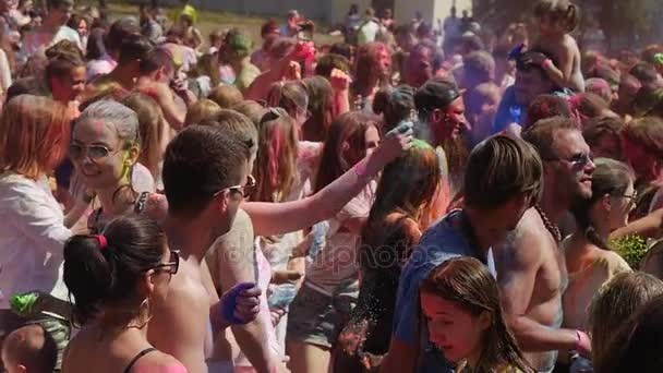 Ragazze che godono e sorridono al Santo Festival dei Colori, vestite con magliette, top leggeri e vestiti, essere colpite su una collina a Kiev in estate — Video Stock