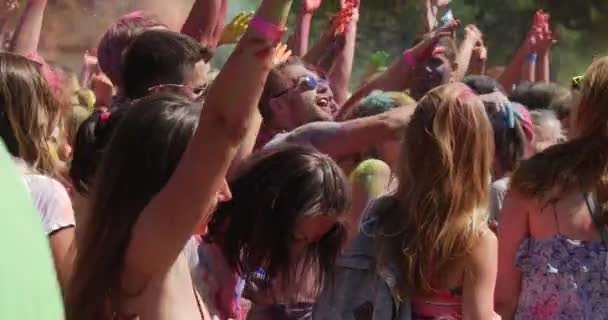 Chicas y niños sonrientes bailando y levantando sus manos, mientras visitan un festival sagrado de colores, organizado por la comunidad india en Kiev en Sumer — Vídeo de stock