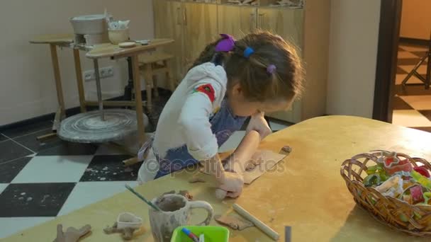 Laborious Six Year Old Blonde Girl in Rolling Out Raw Clay on the Table With a Special Round Stick to Making a Gift From a Clay, — Stock Video