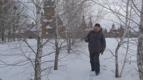 Man Wading Through Birch Grove Wooden Church Skit of All Saints and Park Restored Ancient Buildings Tourist Enjoys the View of Orthodox Ancient Monastery — Stock Video
