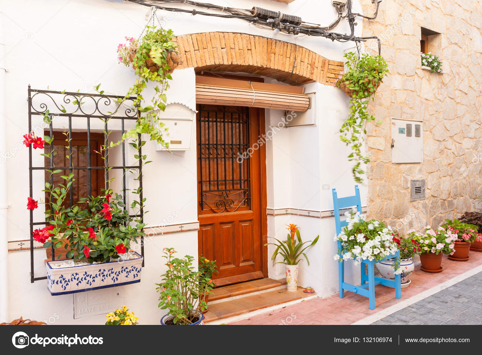 Chair And Flower Pots Decorate Home Exterior In Narrow Spanish T