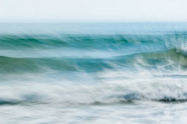 Coastal abstract motion blurred ocean waves blue tones backgroun — Stock Photo, Image